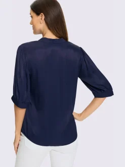 Blouse féminine à manches bouffantes et col montant