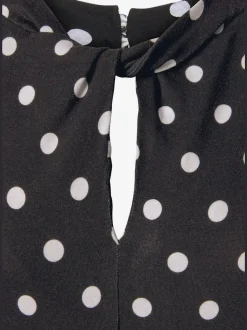 Débardeur à pois avec encolure fendue et sans manches