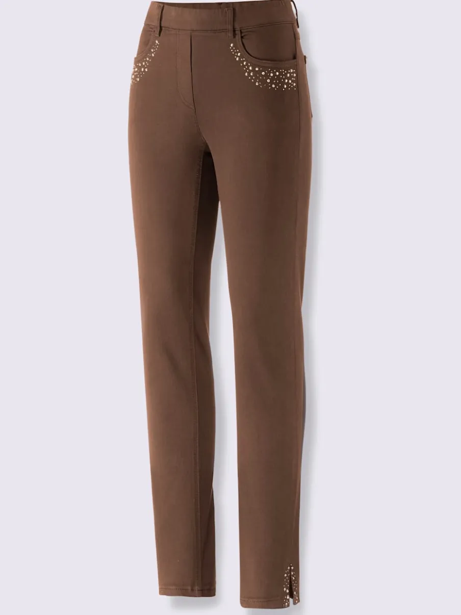 Jean extensible à fausse fermeture avec pierres brillantes et fente