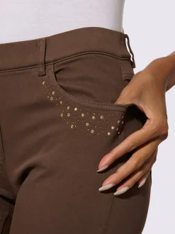 Jean extensible à fausse fermeture avec pierres brillantes et fente