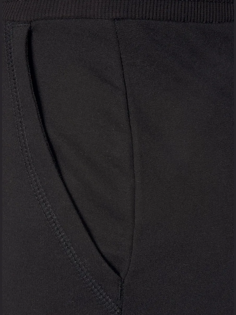 Pantalon confortable avec poches fendues et ourlet à revers