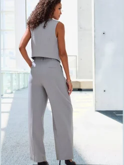 Pantalon large avec pinces à poches fendues et décoratives