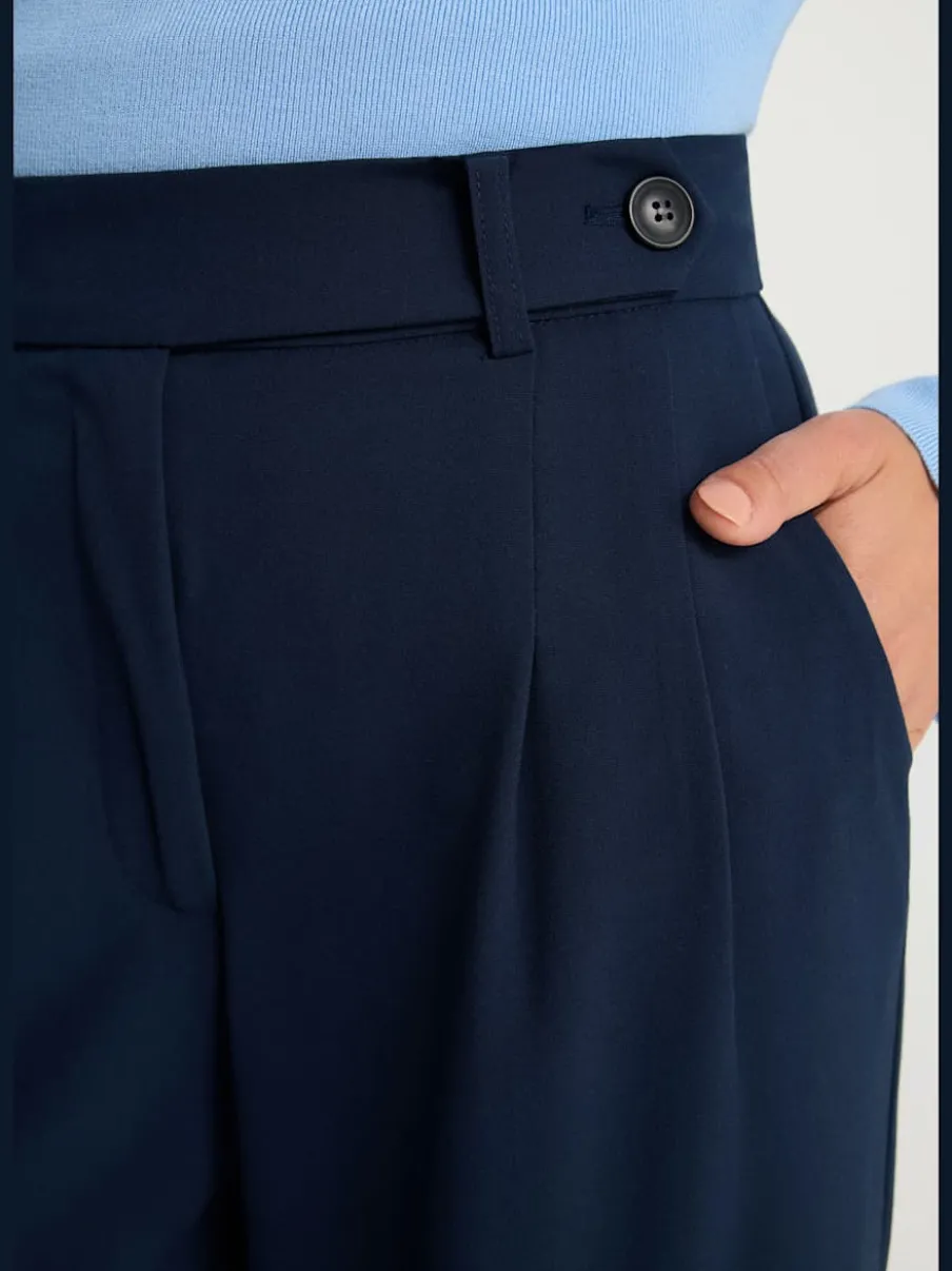 Pantalon large avec pinces à poches fendues et décoratives