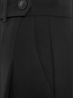 Pantalon large avec pinces à poches fendues et décoratives