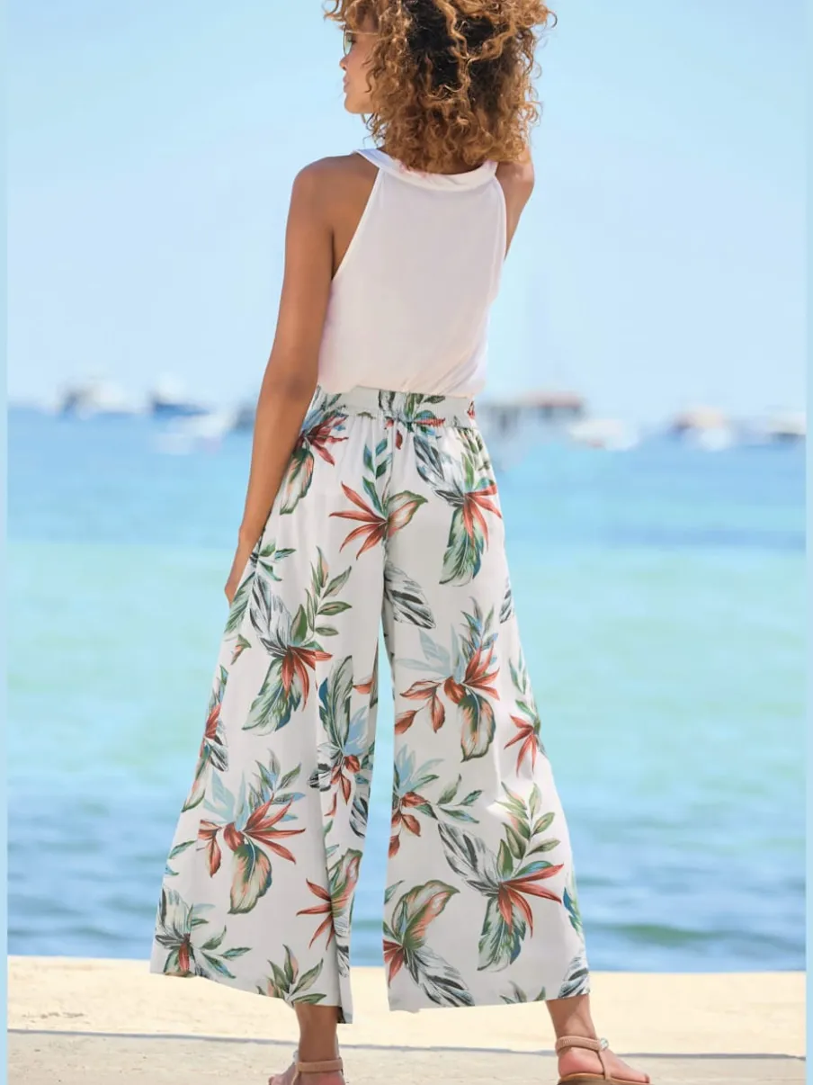 Pantalon large à ceinture plate avec poches fendues et imprimé floral
