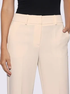 Pantalons à jambes larges avec plis et poches décoratives