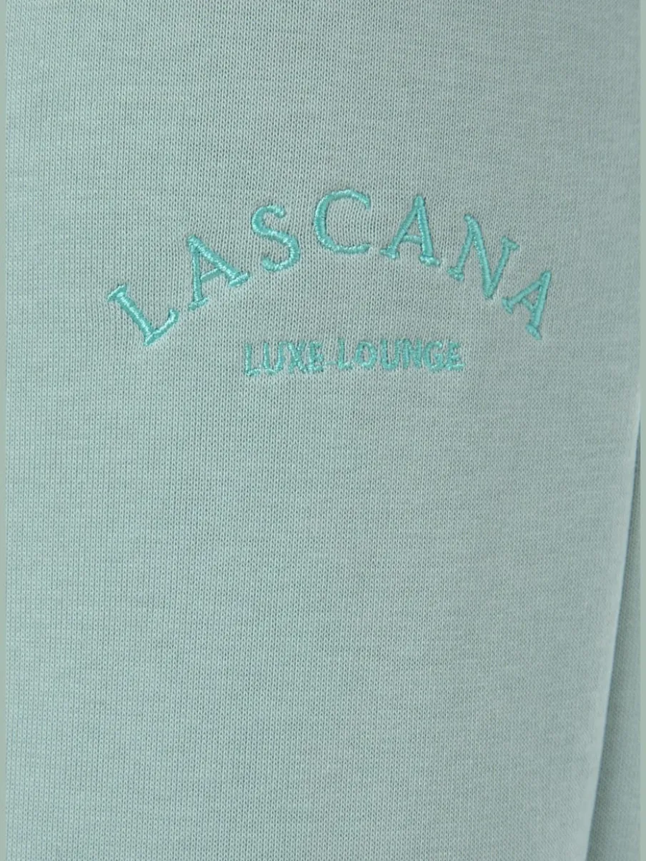 Pantalon sweat avec logo brodé et poches latérales fendues
