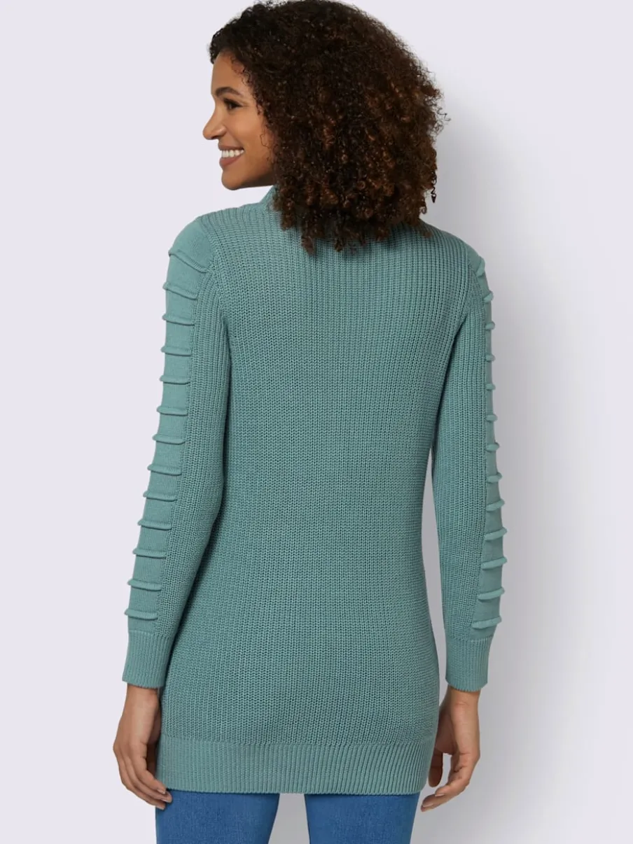 Pull long col roulé manches longues motif structuré moderne