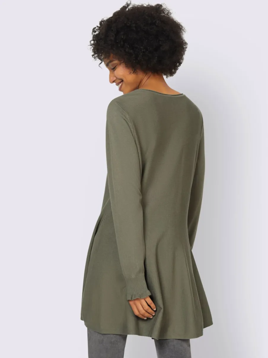 Pull long légèrement évasé avec bords roulés et volants
