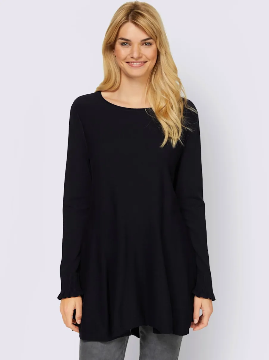 Pull long légèrement évasé avec bords roulés et volants