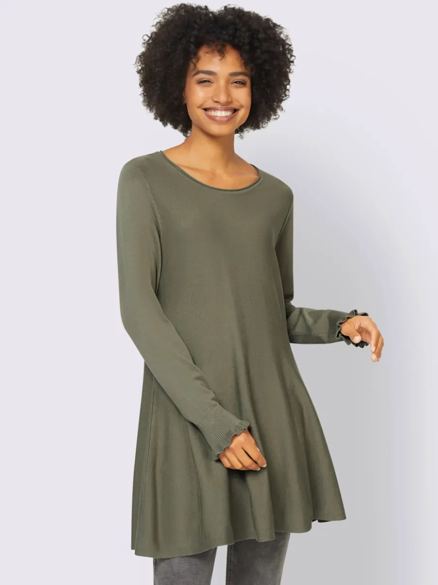 Pull long légèrement évasé avec bords roulés et volants