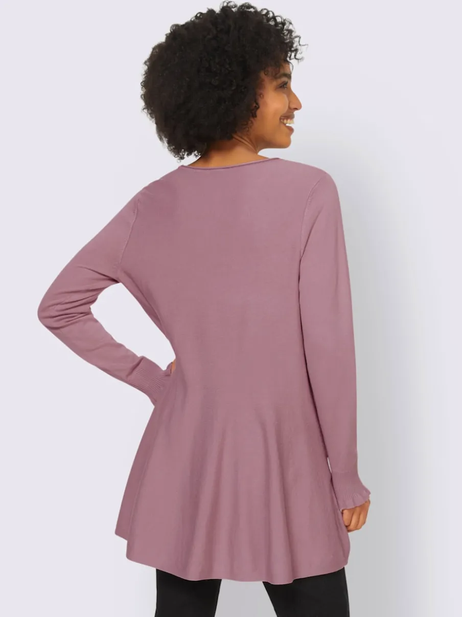 Pull long légèrement évasé avec bords roulés et volants