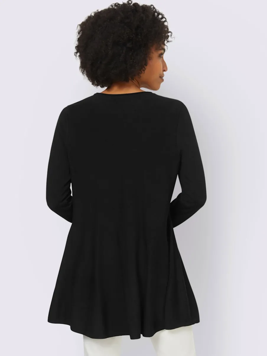 Pull long légèrement évasé avec bords roulés et volants