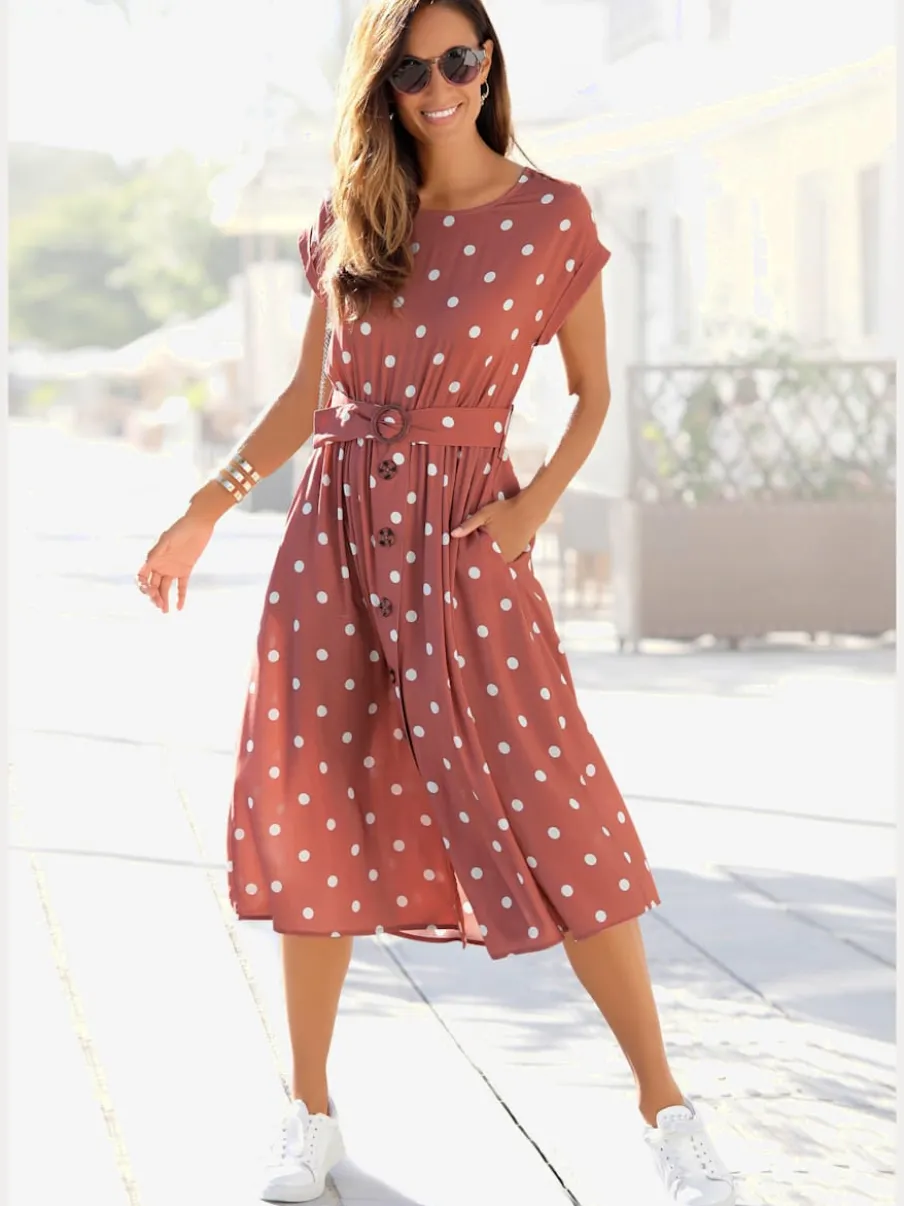 Robe mi-longue à pois avec ceinture et poches latérales