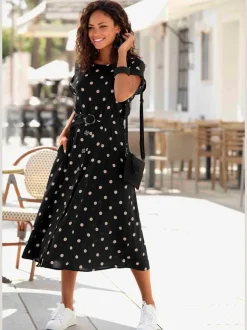 Robe mi-longue à pois avec ceinture et poches latérales