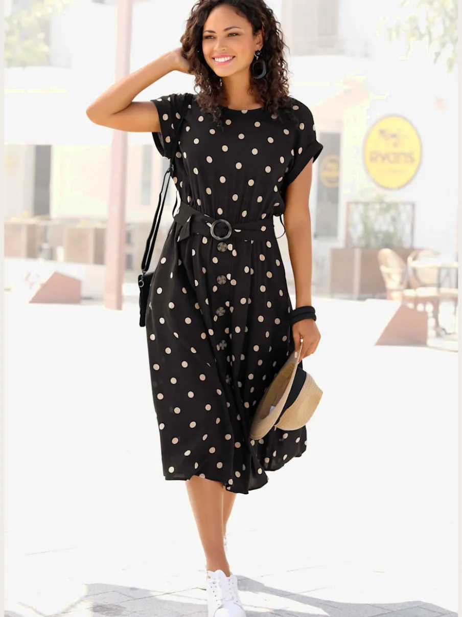 Robe mi-longue à pois avec ceinture et poches latérales