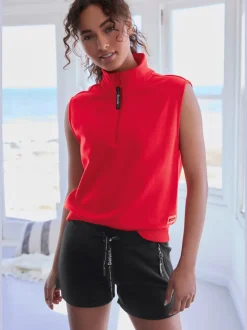 Short en matière sweat avec poches latérales zippées et ceinture élastique