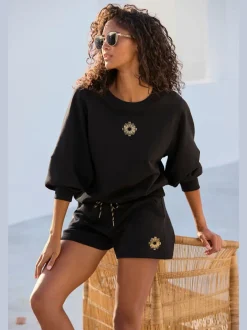 Short en matière sweat avec ruban à coulisse et poches fendues