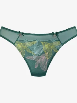 String extravagant avec nœuds décoratifs et accessoires devant sur le côté