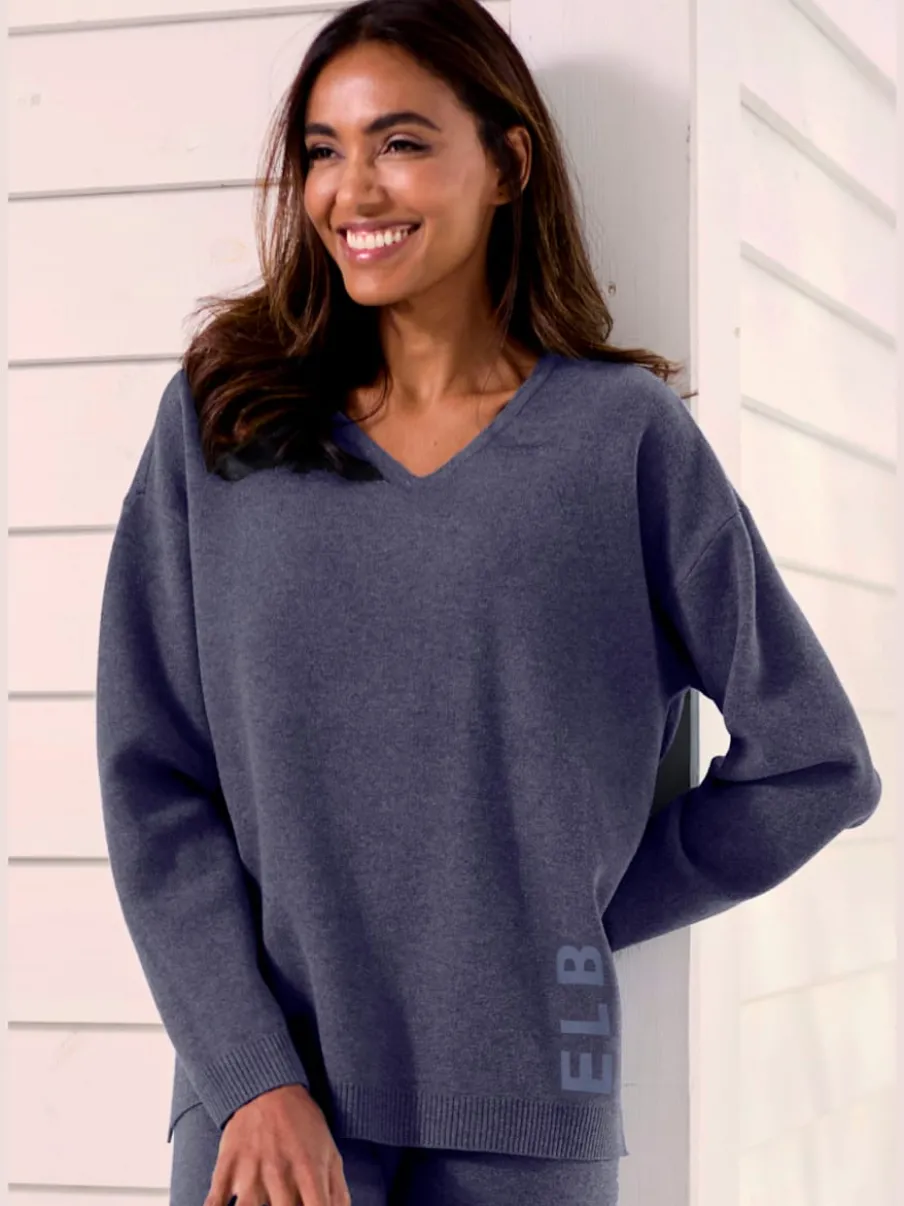 Sweater ample avec encolure en V et manches longues.