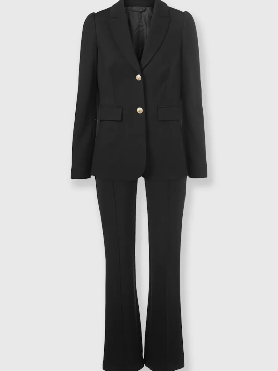 Tailleurs pantalons avec col à revers et manches bouffantes