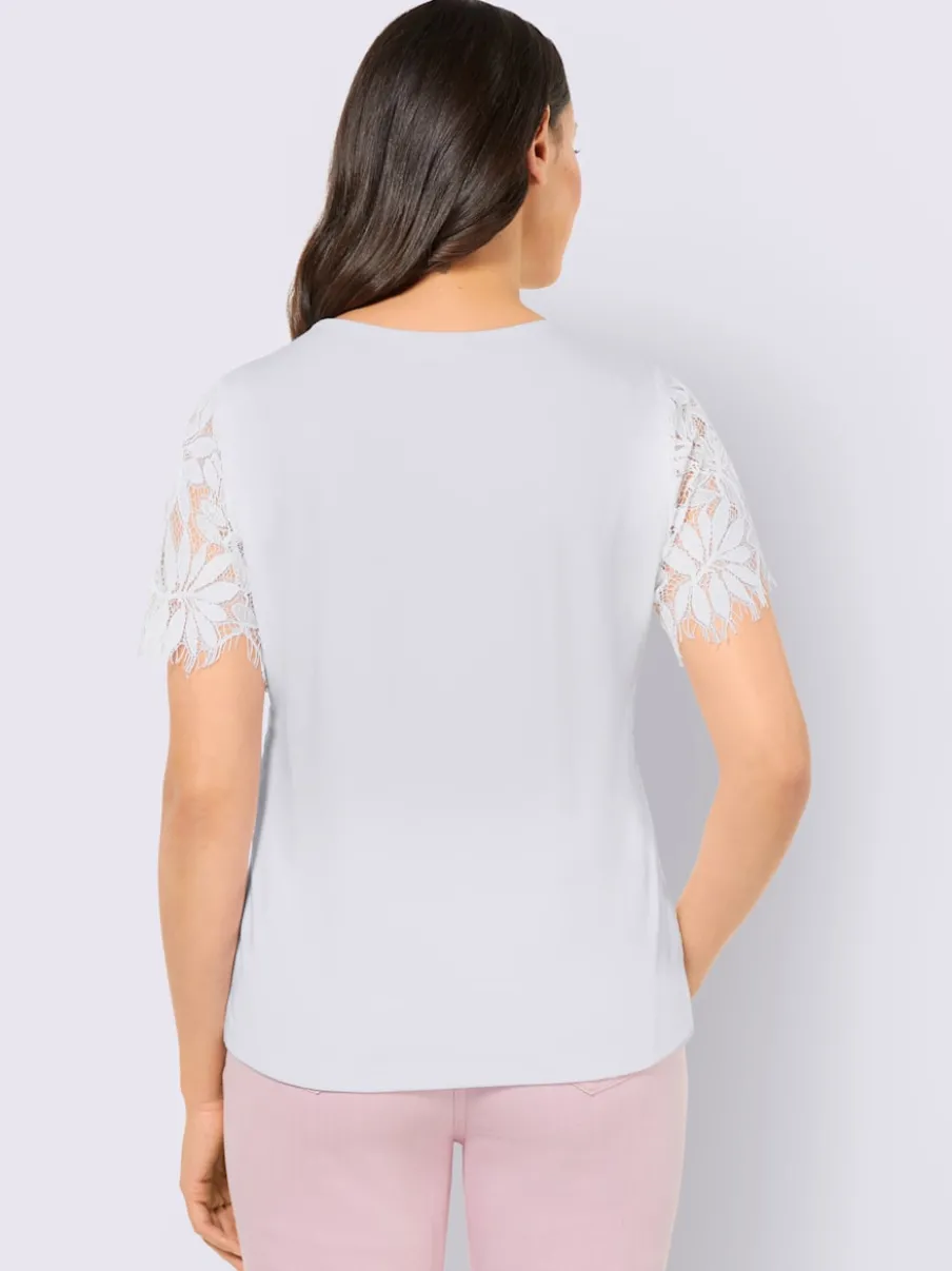 T-shirt en dentelle avec manches transparentes et finitions ondulées