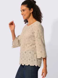 Tunique en dentelle avec encolure ronde et manches trompettes