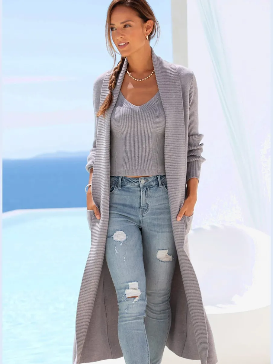 Veste en tricot long avec col châle et poches ouvertes