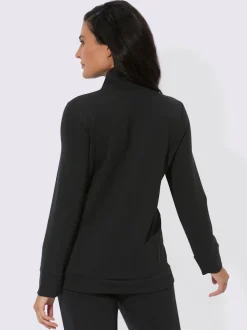Veste interlock à col montant et manches longues intégrant poches.