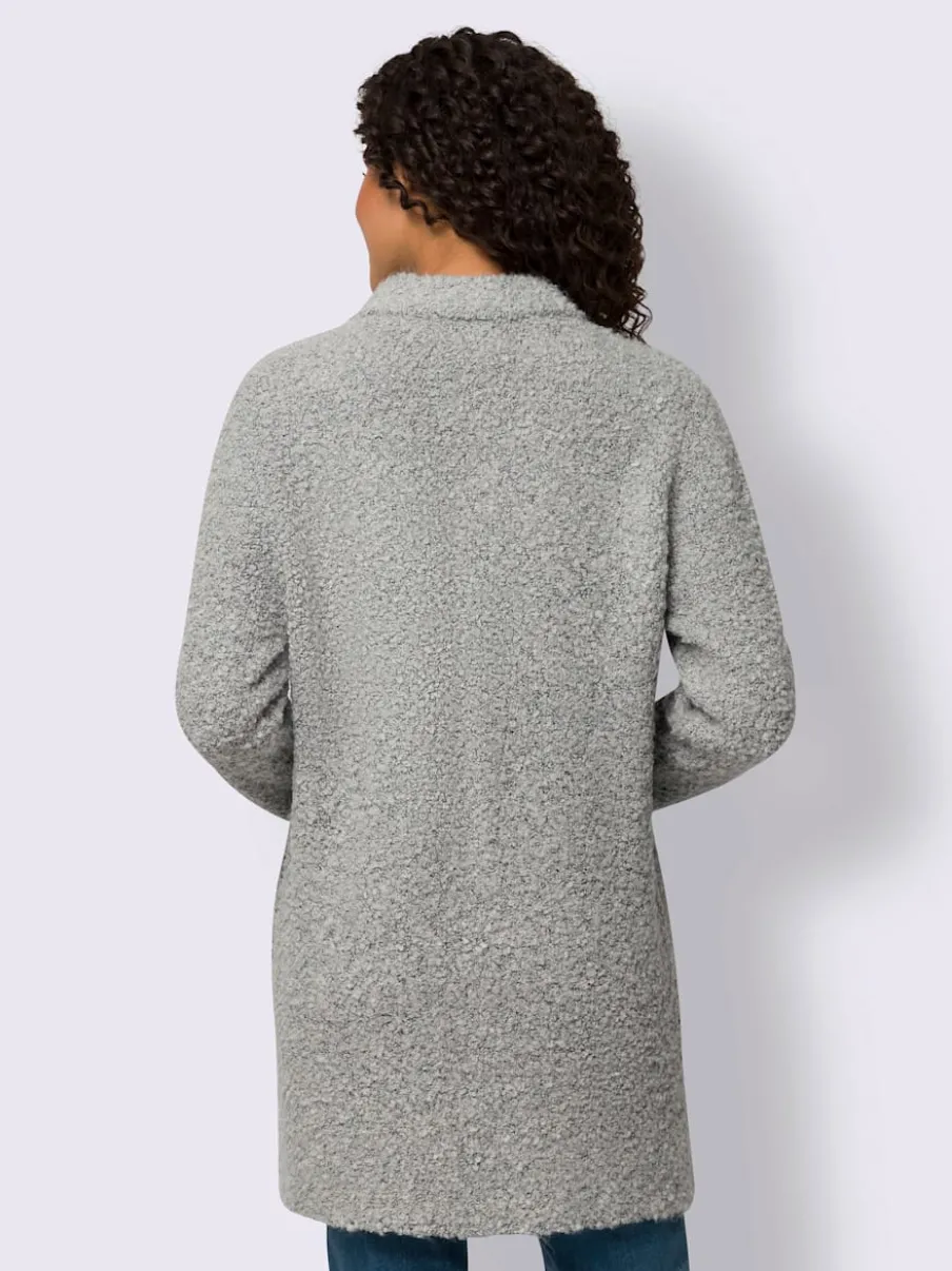 Veste longue en tricot avec col montant et poches plaquées