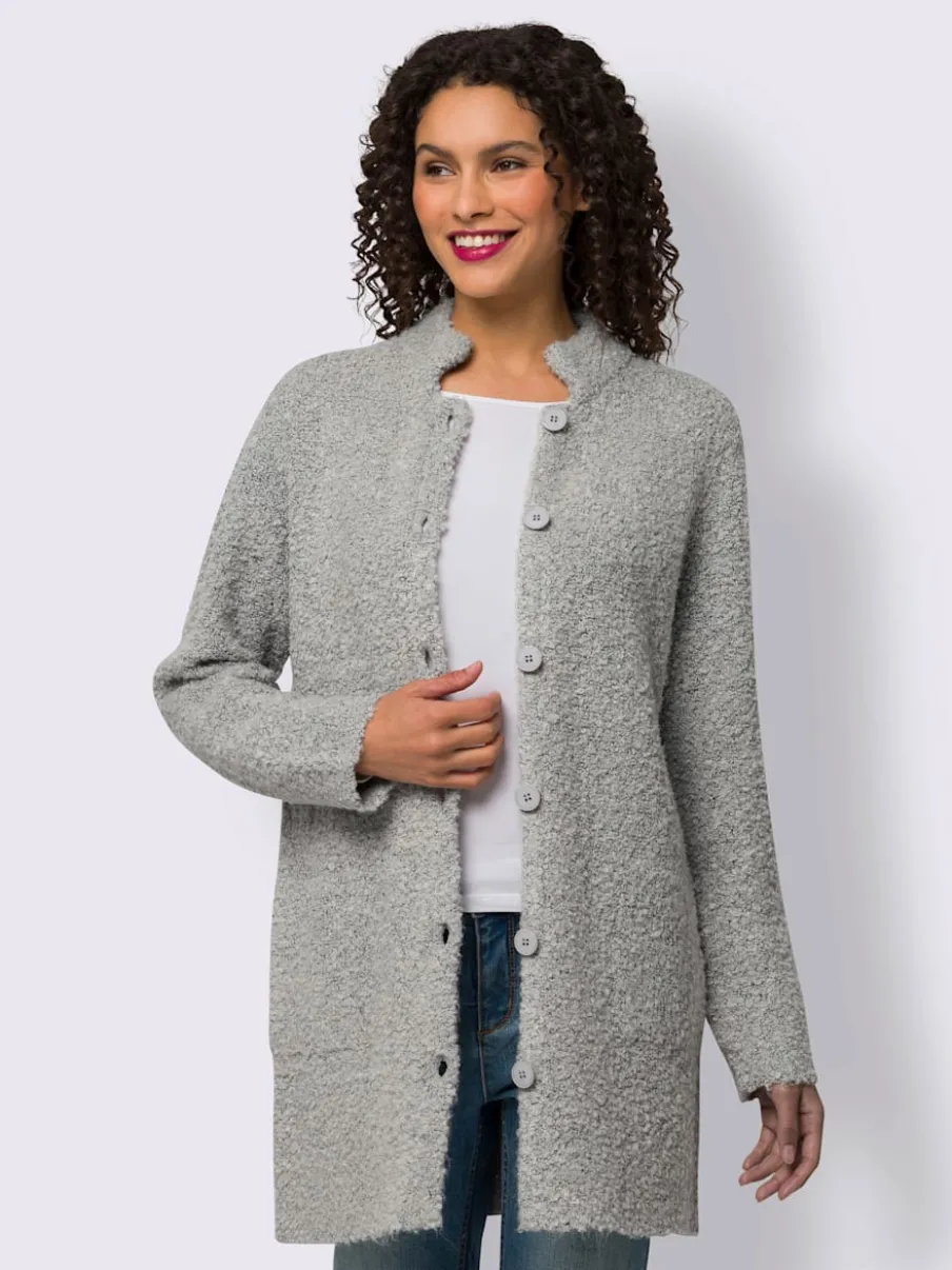 Veste longue en tricot avec col montant et poches plaquées