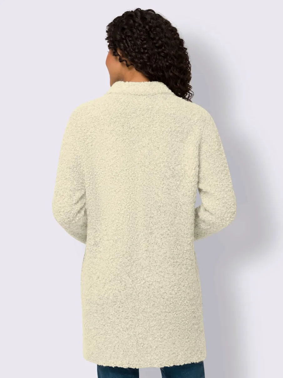 Veste longue en tricot avec col montant et poches plaquées